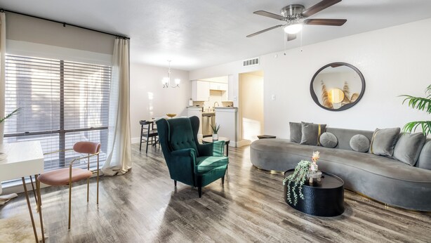 A modern living room with a sofa, armchair, and coffee table. A dining area with a table and chairs is visible in the background. - Walk to AT&T Stadium•Texas Live! & Globe Life (Arlington)