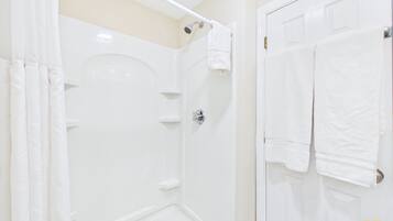 Separate tub and shower, towels, soap, shampoo