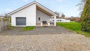 A single-story building with a covered patio area, a garage, and a well-maintained lawn. - "Synne" - 350m from the sea by Interhome (Grenaa)