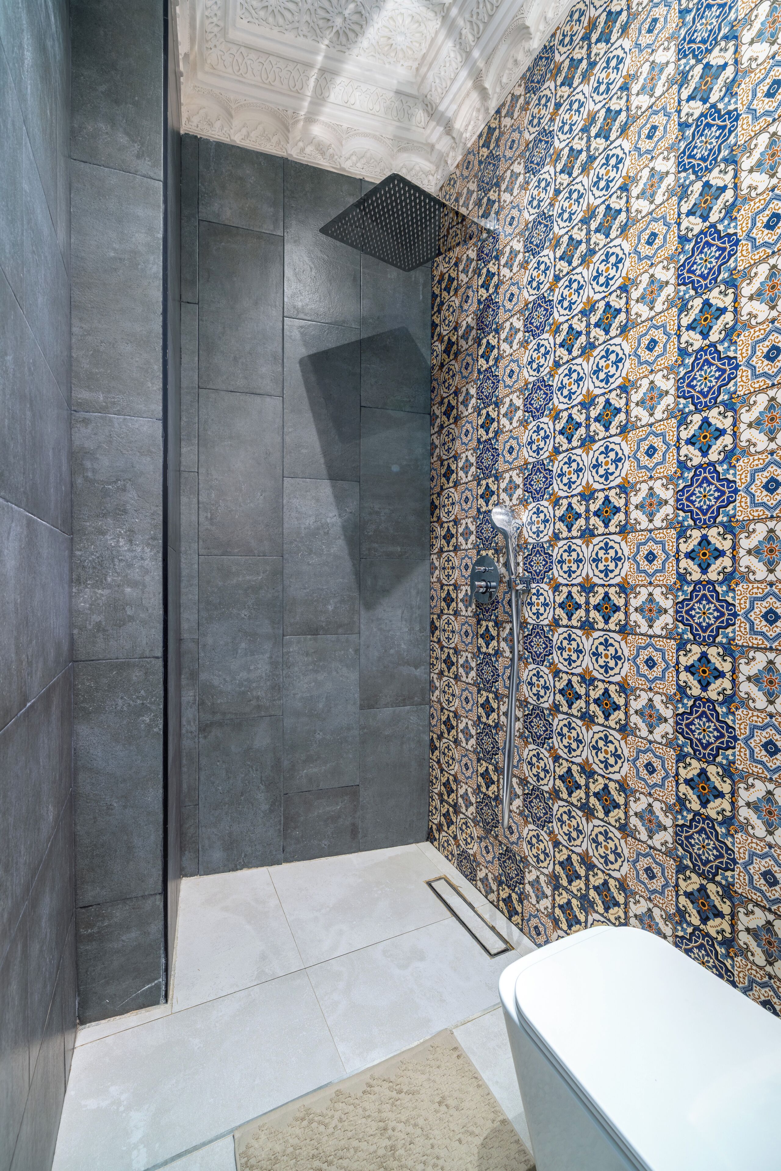 A bathroom with a shower, tiled walls, and a toilet.