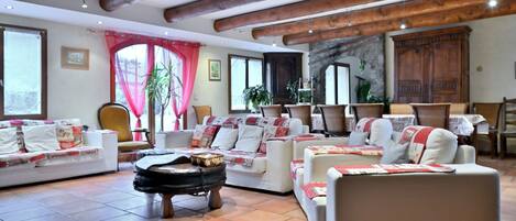 A spacious living room with multiple sofas, a coffee table, and a stone fireplace.