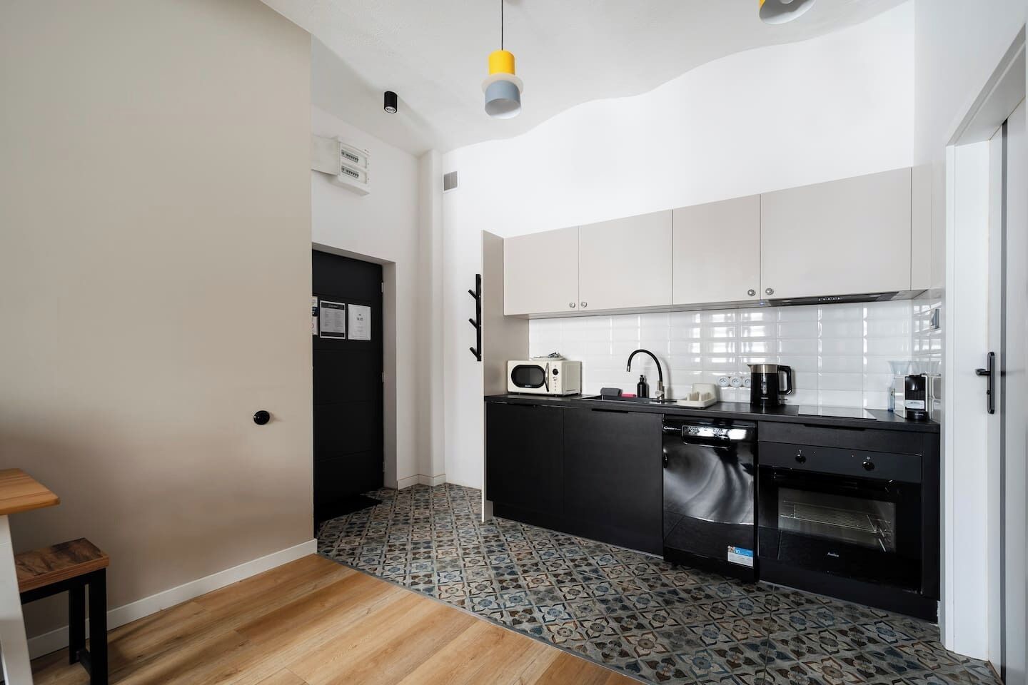 A compact kitchen with a microwave, toaster, sink, and oven.