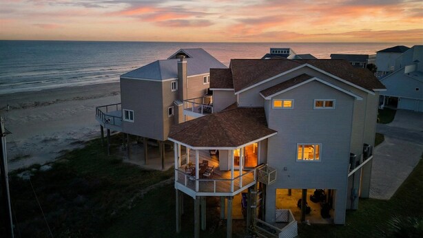 A coastal house with a balcony overlooking the beach, a second-story deck, and a garage. - Beach Diamond - Gulf views, steps to the beach! (Galveston)