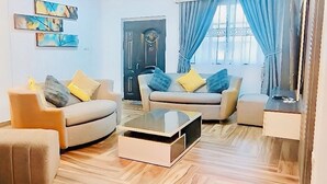 Una sala de estar con dos sofás, una mesa de centro y una chimenea de piedra.