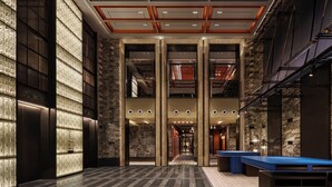 A spacious lobby with a checkered floor, large columns, and a reception desk. - Andaz Shanghai ITC (Shanghai)