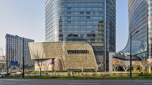 A modern building with a curved facade and a prominent 'ANDAZ' sign at the top. - Andaz Shanghai ITC (Shanghai)