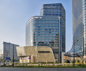 A modern building with a curved facade and a prominent 'ANDAZ' sign at the top. - Andaz Shanghai ITC (Shanghai)