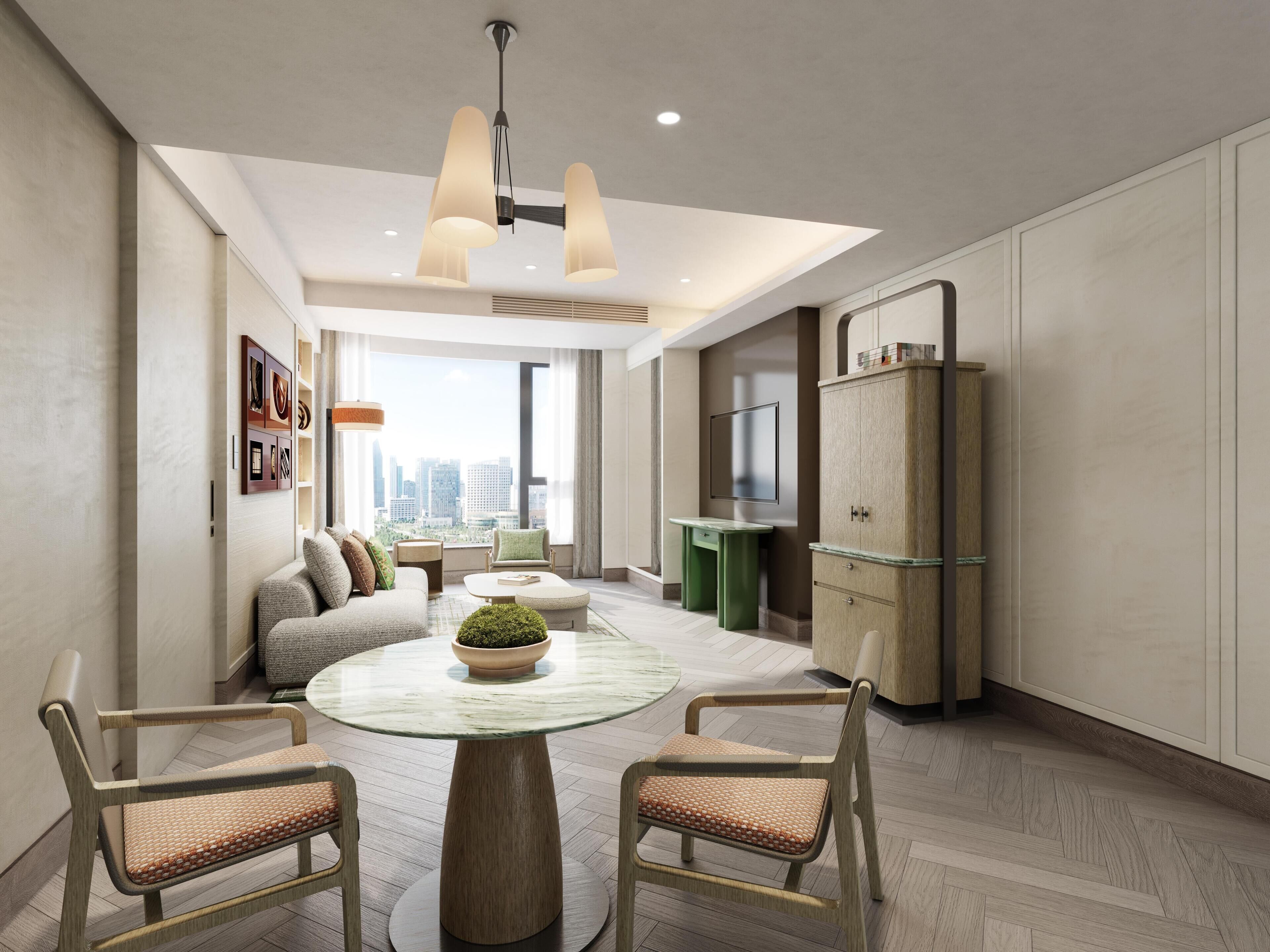 A modern living room with a round glass table, two chairs, a sofa, a TV, and a cabinet.