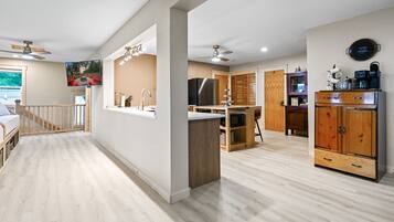 A modern kitchen with wooden cabinets, a refrigerator, and a built-in oven.