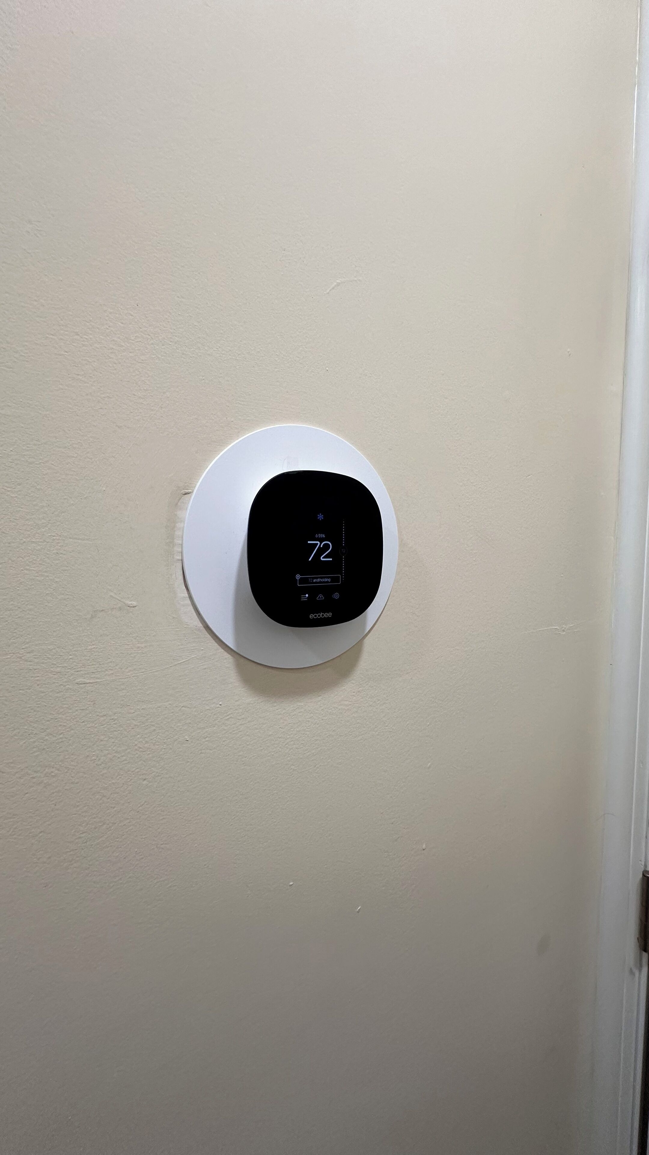 A thermostat mounted on a wall.