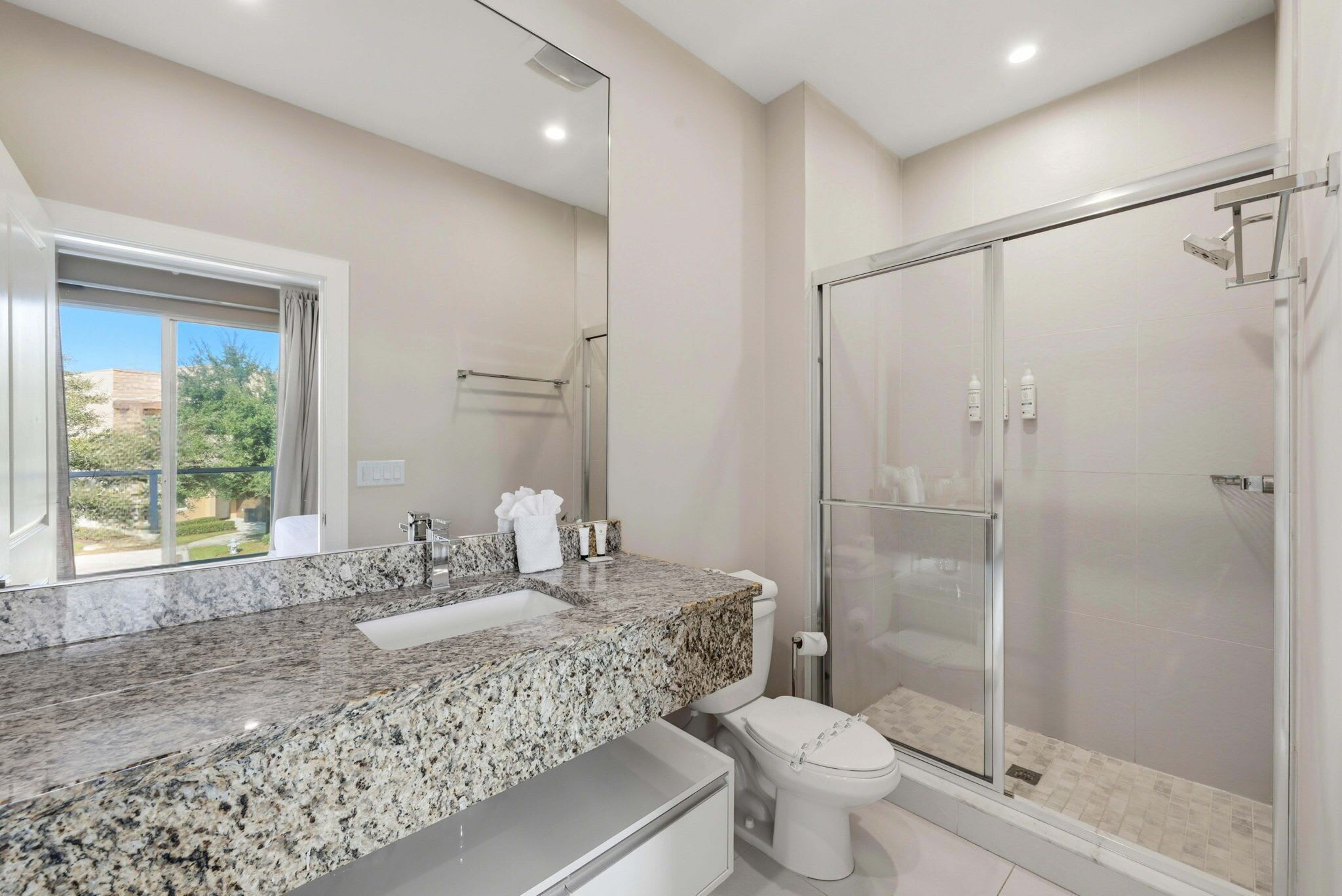 Shower, hair dryer, towels, shampoo