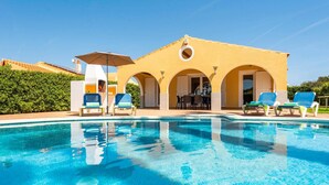 A pool area with lounge chairs and an outdoor seating area with tables and chairs. - Villa Marte by Villa Plus (Cap d'Artrutx)