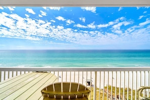 A wooden deck with a view of the ocean and beach. - Seychelles 602 (Panama City Beach)