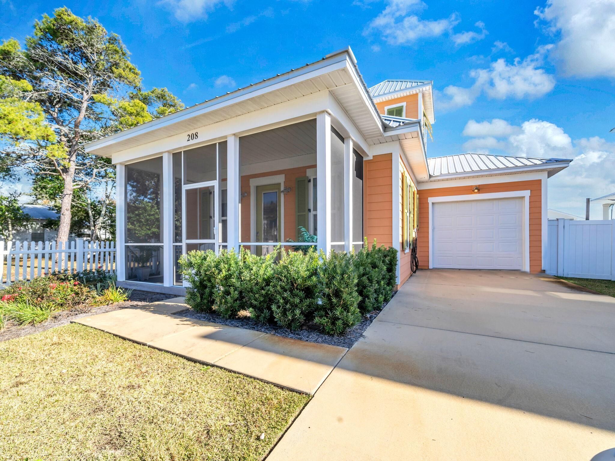 A single-story house with a covered porch, a garage, and a well-maintained lawn.