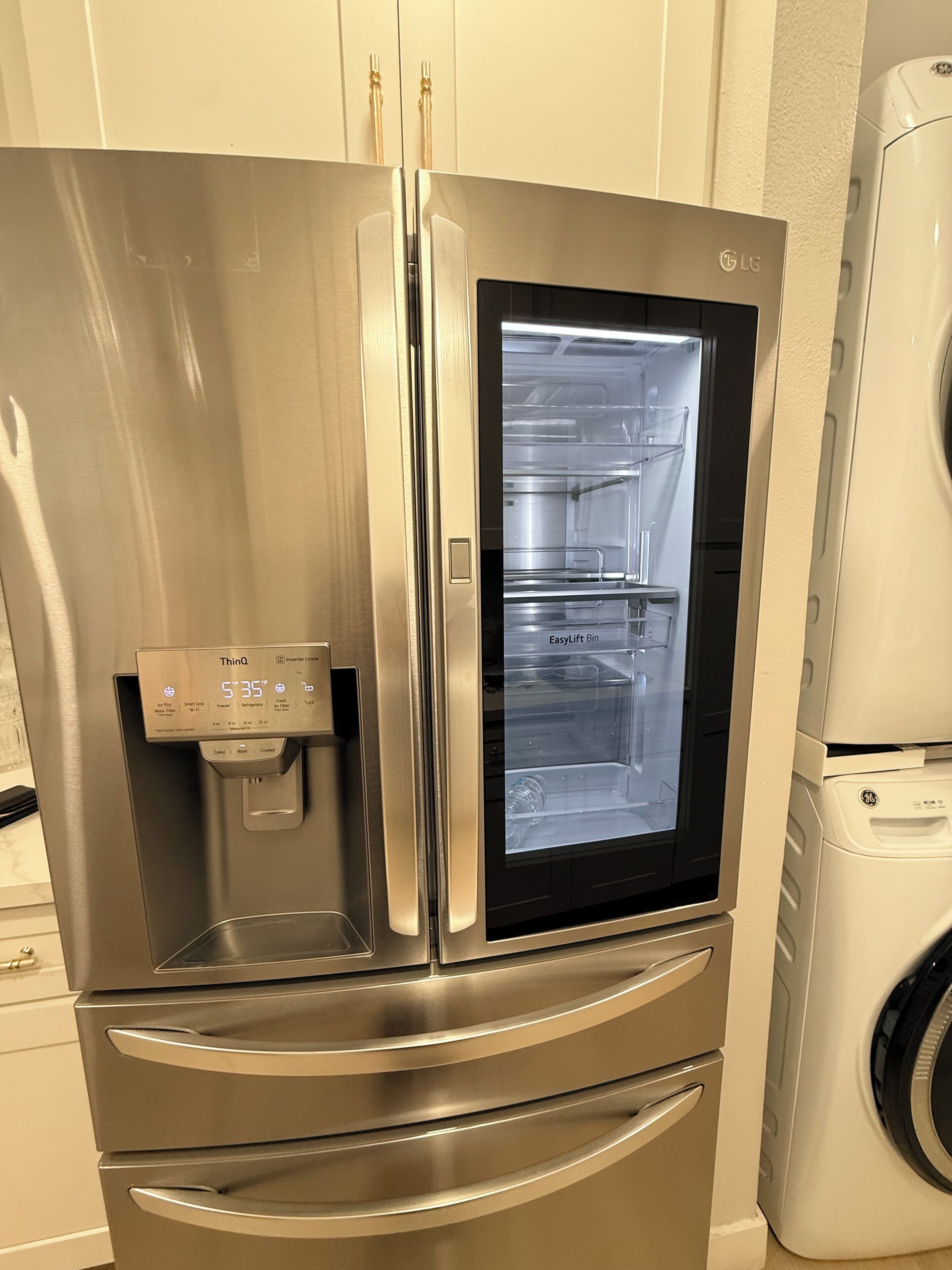 A stainless steel refrigerator with a water dispenser and a freezer compartment.