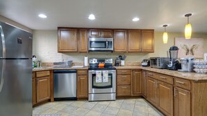 A modern kitchen with wooden cabinets, stainless steel appliances, and pendant lighting. - Remote-Work Hub! DC Unit 1 Mi to Rock Creek Park (Washington)