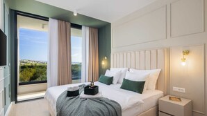 A modern hotel room with a large bed, a nightstand, a view of the city, and a window with curtains. - Luxury Villa Nikandra with Pool (Žrnovnica)