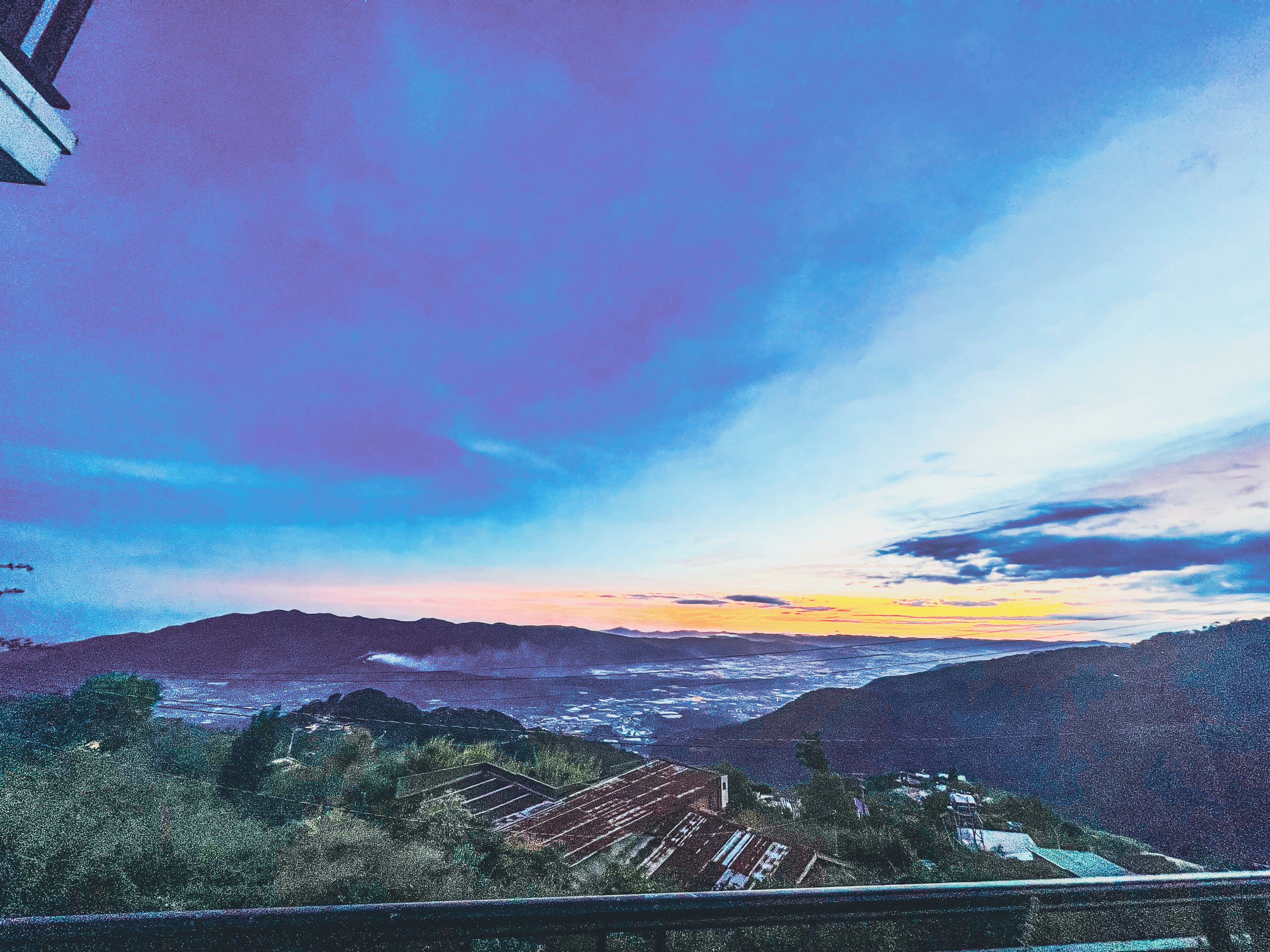 A mountainous landscape with a sunset.