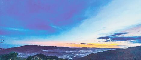 A mountainous landscape with a sunset.