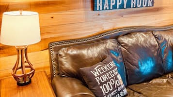 A wooden wall with a shelf displaying bottles and a sign that reads 'HAPPY HOUR'.