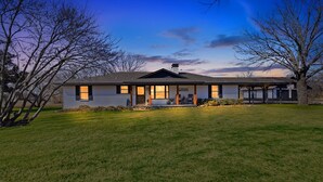 A two-story house with a front porch and a garage. - Quiet Farm, Gameroom, Firepit 2 Mi to McKinney (McKinney)