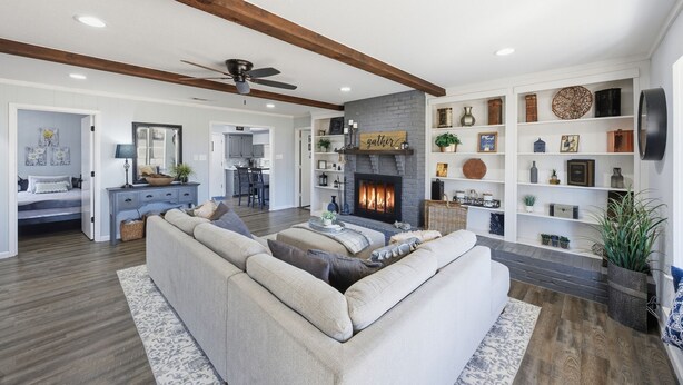 A living room with a fireplace, a sofa, and a bookshelf. - Quiet Farm, Gameroom, Firepit 2 Mi to McKinney (McKinney)