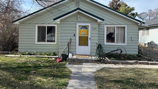 A single-story house with a front door, two windows, a small porch, and a satellite dish. - Kid & Pet-Friendly Rainbow Cottage in the Heart of Arco (Arco)