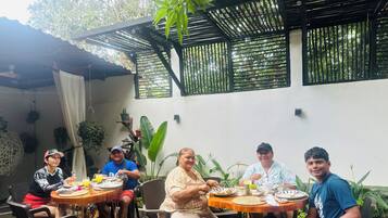 Quadruple Room, Multiple Beds, Balcony, Garden View | Outdoor dining