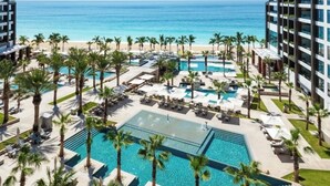 A resort with multiple swimming pools, palm trees, and a beach view. - Charming Garza 5+ Diamond resort in Cancún, enjoy and relax! (Cancún)