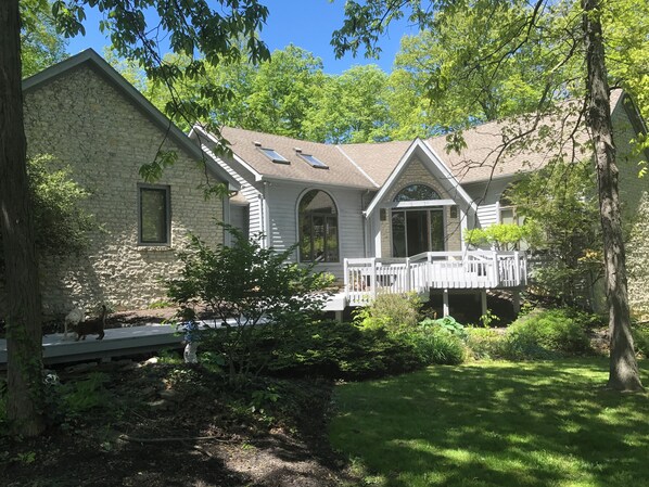 A stone house with a porch and a covered entryway.