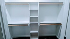 A walk-in closet with multiple shelves and a central hanging rod. - 99 per Night - New home next to KimberlyClark.662 - cleaning &taxes not included (Paris)