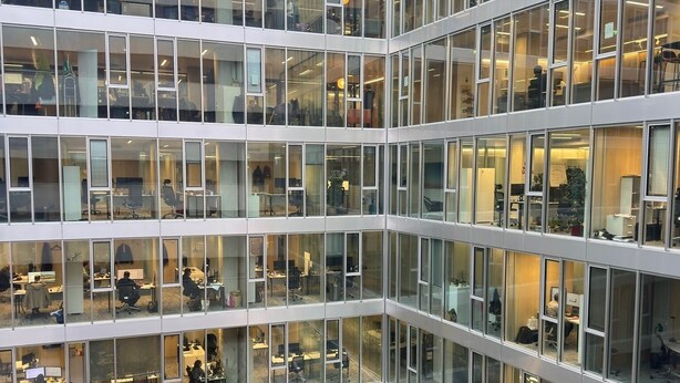 A multi-story office building with numerous glass windows and a central atrium. - Central Cozy Apartment Paris 2nd District (Paris)