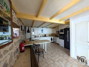A spacious kitchen with white cabinets, a wooden ceiling, and a tiled floor. - Le Paradis Perdu - SAINT-IGNY-DE-VERS (SAINT-IGNY-DE-VERS)