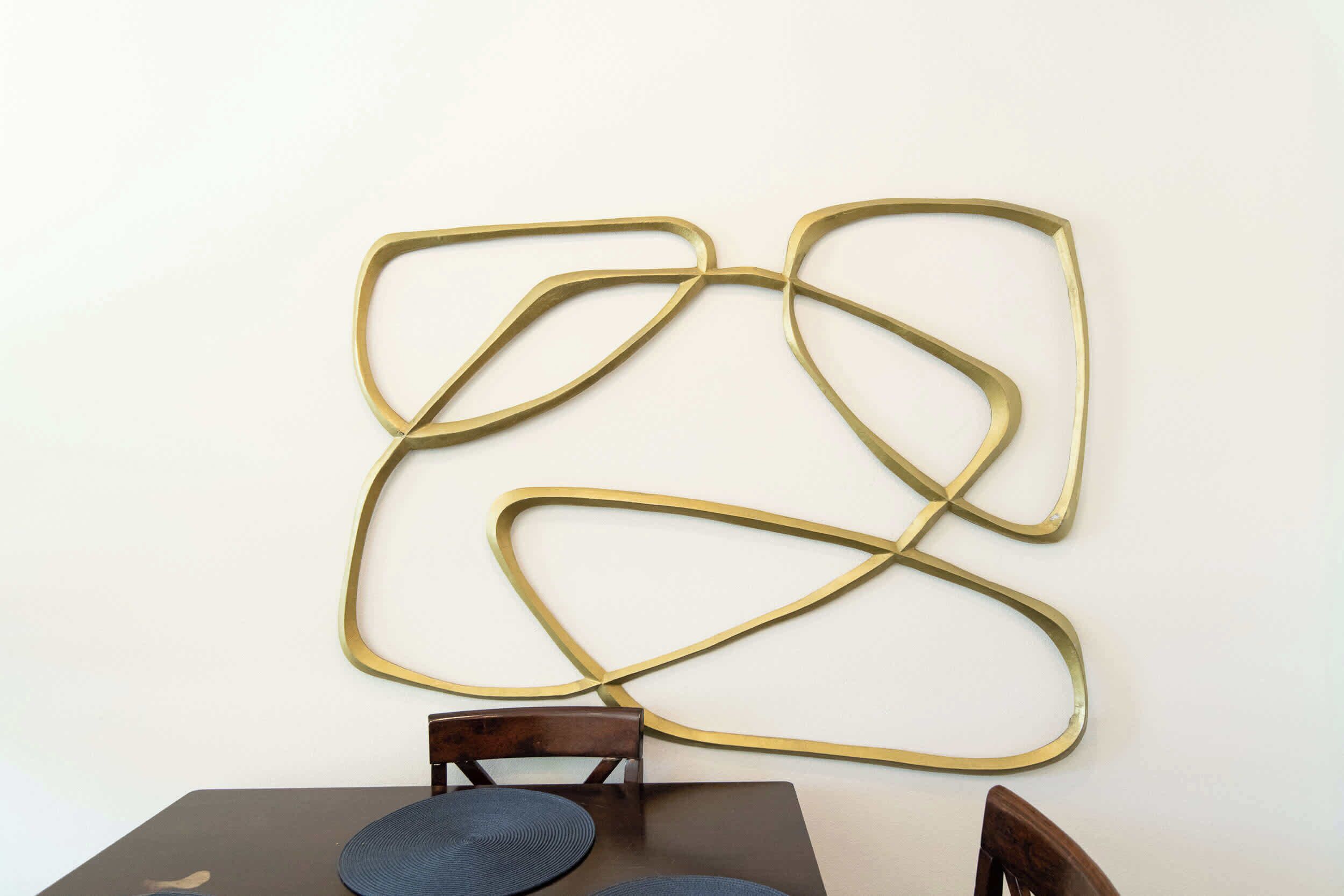 A wall-mounted abstract art piece with a geometric design.