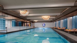 An indoor swimming pool with clear water, lounge chairs, and modern lighting fixtures. - Renaissance Hangzhou Lin'an Hotel (Hangzhou)