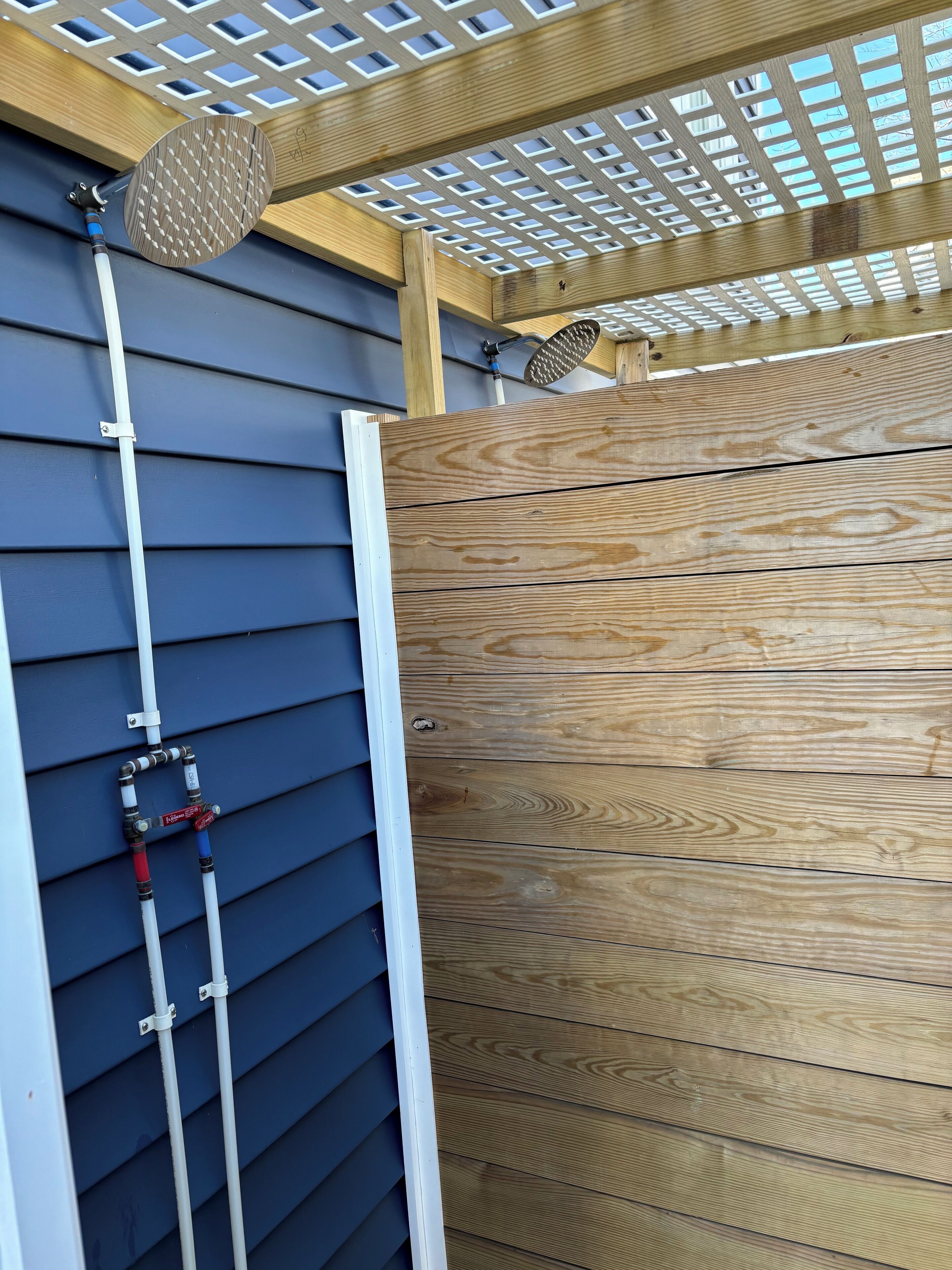 A wooden deck with a ceiling fan and a window with a grid pattern.