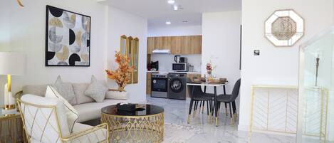 A modern living room with a sofa, coffee table, and decorative elements.
