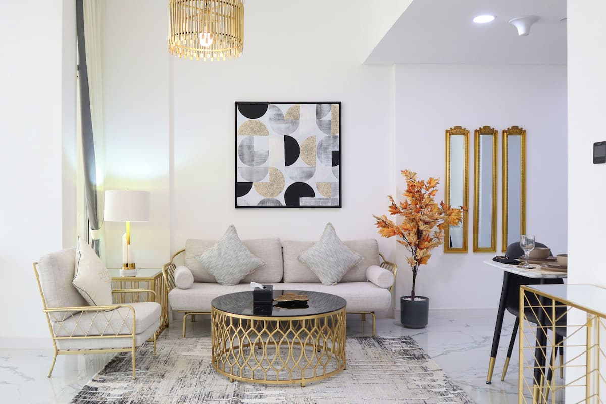 A modern living room with a sofa, coffee table, and decorative items.