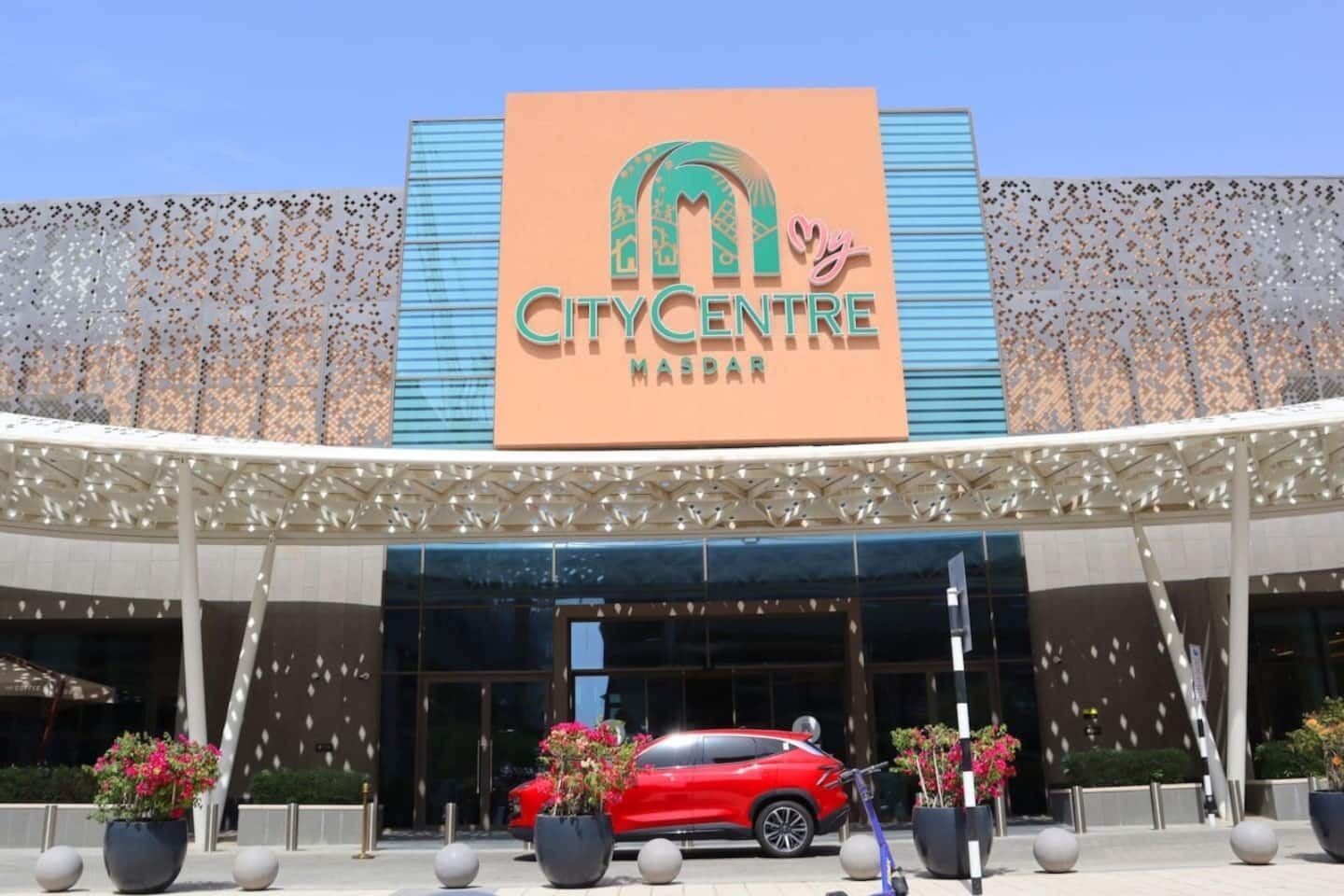 The exterior of the City Centre Marriott hotel with a red car parked in front.