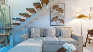 Apartment (G06) | Living area | 58-inch flat-screen TV with cable channels