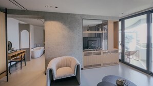 A modern interior with a large window, a bathtub, a wooden desk, and a cozy armchair. - Zins Luxury Room 04 in Durr s (Durrës)