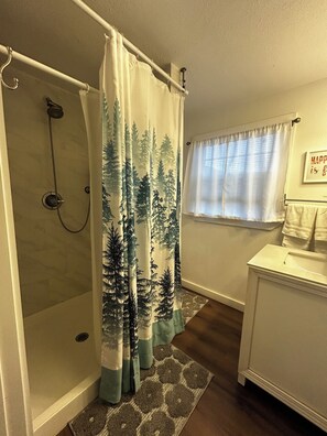Shower, hair dryer, towels, toilet paper