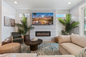 TV, fireplace - Modern Beach Getaway: Walk to Beach, Heated Pool, Hot Tub, Mini-Golf, Playground (St. Augustine)