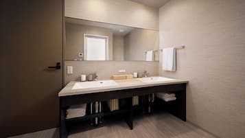 A modern bathroom with a double sink, a large mirror, and a towel rack.
