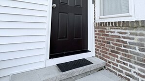 A front door with a black door and a window above it. - 2BR Steps to Boardwalk & Beach, Walk to Casinos (Atlantic City)
