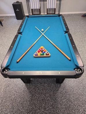 A pool table with a triangular rack of billiard balls, two cue sticks, and a cue ball. - New Listing! Private Pool & Hot Tub! Near the Beach! (Panama City Beach)