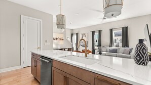 A modern kitchen with a large island, stainless steel appliances, and pendant lighting. - 27 Beds / Rooftop Hot Tubs + CityViews + Game Room (Nashville)
