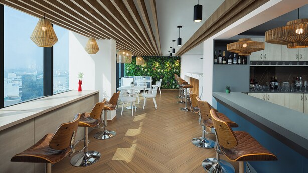 Un área de bar moderna con piso de madera, taburetes y lámparas colgantes.