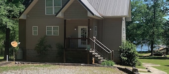 Lake side apartment with shared 100’ pier and pavilion with rock BBQ pit.