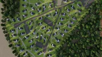 Vue aérienne d’un quartier résidentiel avec de nombreuses maisons, des rues et des espaces verts.